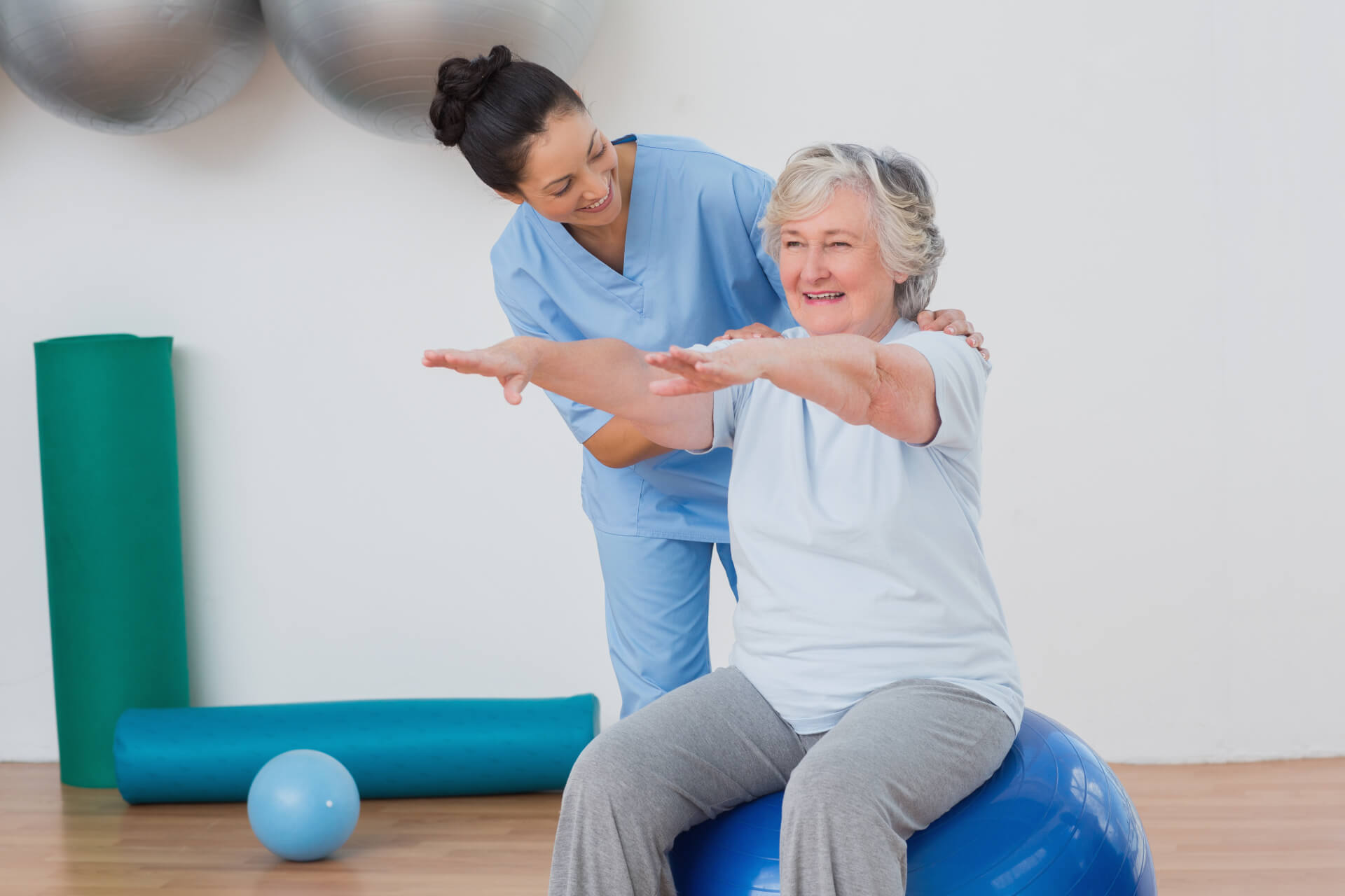 instructor-assisting-senior-woman-exercising (1) (1)